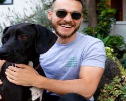 The actor has adopted a black dog and plays with him whenever he is at home.